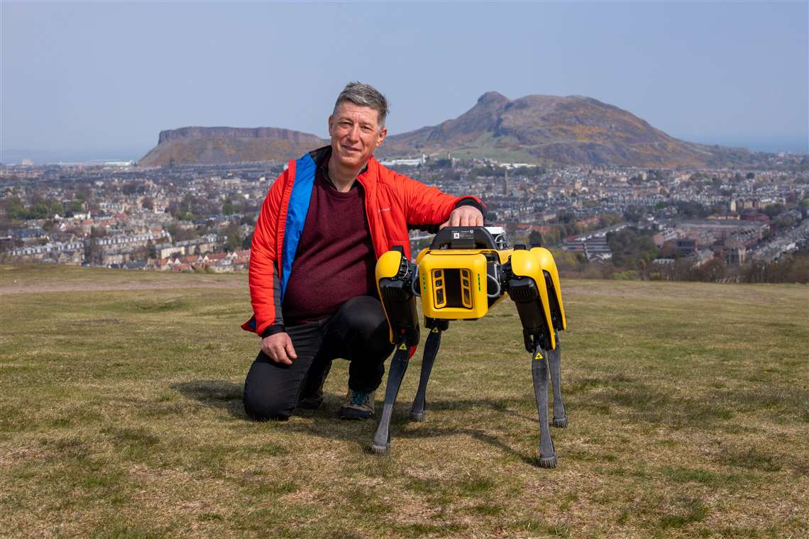 Prof Yvan Petillot, professor of robotics and autonomous systems at Heriot-Watt University and co-academic lead of the National Robotarium, with the new robot sitting