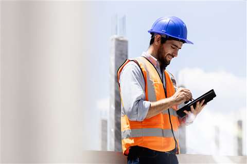 Technology on a tablet in use by a construction worker