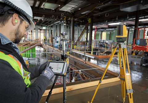 A worker uses the new Digital Layout software from Topcon on a construction site